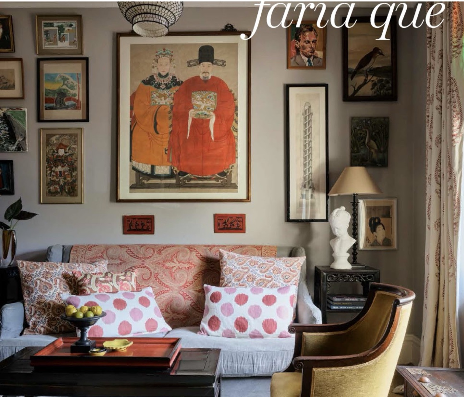 Art-filled sitting room with a large portrait, salon-style collection of framed works, patterned textiles and a sculptural bust